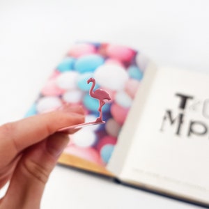 Pink metal bookmark Flamingo. A long, flat metal stick stays between the pages of the book - Cool Bookmark