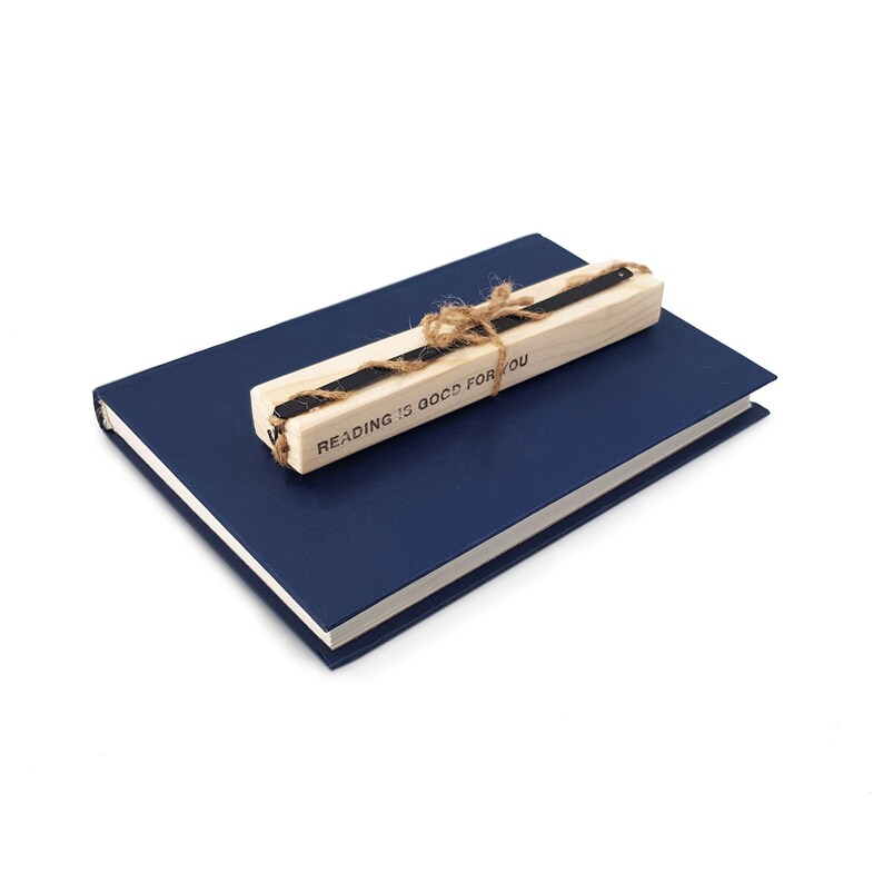 May include: A blue hardcover journal with a wooden bookmark that says "Reading is good for you".