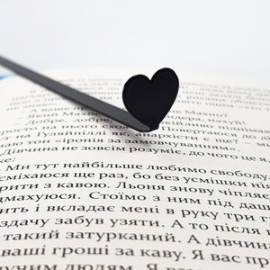 Black metal bookmark in the book.