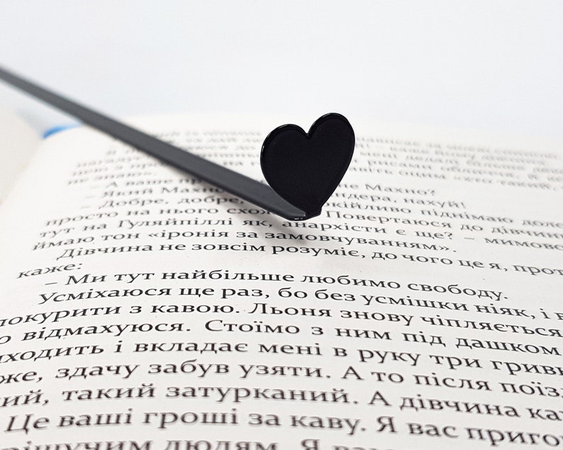 Black metal bookmark in the book.