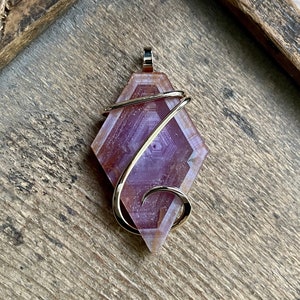 Ruby slice in 14kt gold pendant