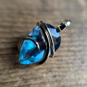 Faceted fluorite in forged 14k gold pendant