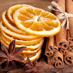 May include: A close-up of dried orange slices, cinnamon sticks, and star anise. The orange slices are stacked on top of each other, and the cinnamon sticks are tied together with twine. The star anise is in the foreground.