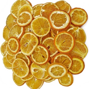May include: A pile of dried orange slices, ideal for crafting or decorating. The slices are a vibrant orange colour and have a natural, rustic look.