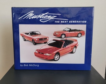 May include: A book titled "Mustang: The Next Generation" by Bob McClurg, featuring a red 1994 Ford Mustang convertible on the cover.