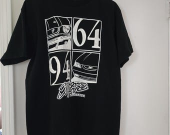 May include: Black t-shirt with a white graphic of four Ford Mustang cars and the text "30 YEARS MUSTANG" printed on the front.
