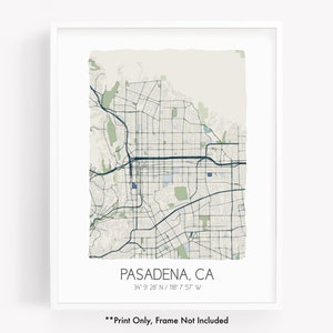 May include: A framed print of a map of Pasadena, CA, with a white border. The map features a grid of streets and highways in shades of blue and green against a light beige background. The text "PASADENA, CA" and coordinates are printed at the bottom.