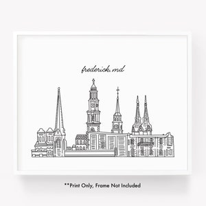 May include: Black and white line art print of the Frederick, MD skyline. The print features detailed illustrations of various buildings and church steeples. The text "frederick, md" is written above the skyline. The text "**Print Only, Frame Not Included" is written below the skyline.