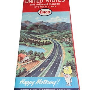 May include: A vintage Enco gas station map of the Eastern United States and adjacent Canada. The map features a scenic highway with mountains in the background and a cartoon character mascot. The text on the map reads "Eastern United States and Adjacent Canada Interstate Map Enco Happy Motoring! Humble Oil & Refining Company America's Leading Energy Company"