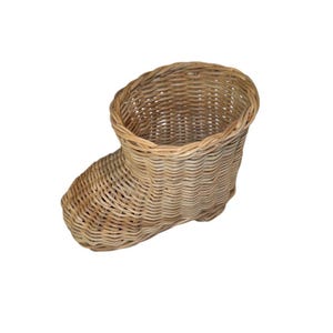 May include: A woven wicker basket shaped like a boot. The basket is light brown and has a rounded opening at the top. The boot-shaped basket is made of woven wicker.