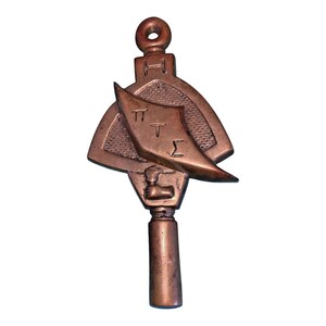 May include: A bronze key with a triangular head featuring the Greek letters ΠΤΣ and the letter H. The key has a long, cylindrical shaft.