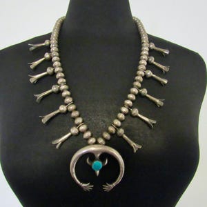 1970s Navajo Sterling Silver & Turquoise Squash Blossom Necklace with Cast Naja that has central Fleur de Lis and Hands