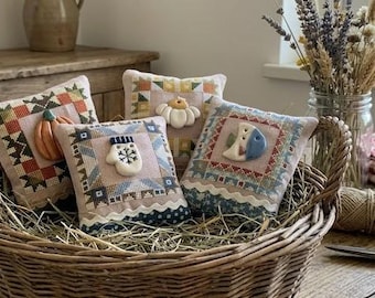 Korsstygnsdiagram och knapp med fyra årstiders patchwork-tema