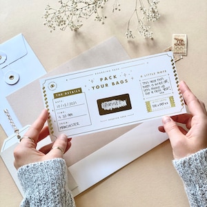 Lux Travel Scratch Card Announcement Boarding pass, with gold foil. Here we see the handwritten boarding pass scratched to see the destination. Designed by Rodo Creative