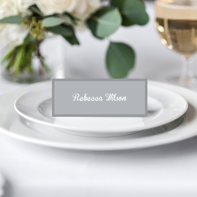 Matching Find your face place cards, elegant grey background with a decorative font.