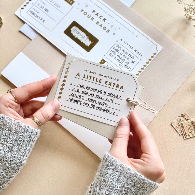 Lux Travel Scratch Card Announcement Boarding pass, with gold foil. Here we see the handwritten boarding pass scratched to see the destination. With a meal telegram and little extra card. Designed by Rodo Creative