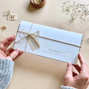 Lux Travel Scratch Card Announcement Boarding pass, with gold foil. Here we see the personalised wallet with name.  Designed by Rodo Creative