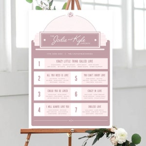 May include: A pink and white wedding seating chart with the title "The Jodie and Kyle Jukebox" and the date "11th June 2022". The chart lists the names of guests assigned to tables with song titles like "Crazy Little Thing Called Love", "All You Need Is Love", "Could You Be Loved", "Crazy In Love", "I Will Always Love You", and "Endless Love".