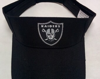 Oakland Raiders Heat Applied Applique on a Black team color Visor hat cap! Adjustable strap. Fits everyone!