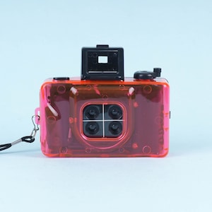 35mm P&S film camera with 4 lenses. Plastic Fantastic! Great for lomography. NEW, unused pink point and shoot sports camera with four lenses
