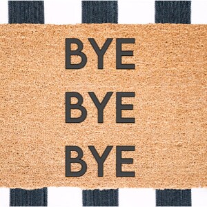 May include: A brown coir doormat with the words "BYE BYE BYE" printed in black.