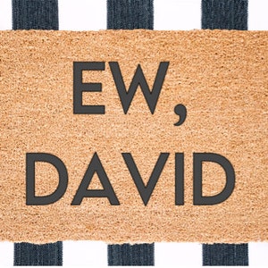 May include: A brown doormat with the text "EW, DAVID" in black letters.