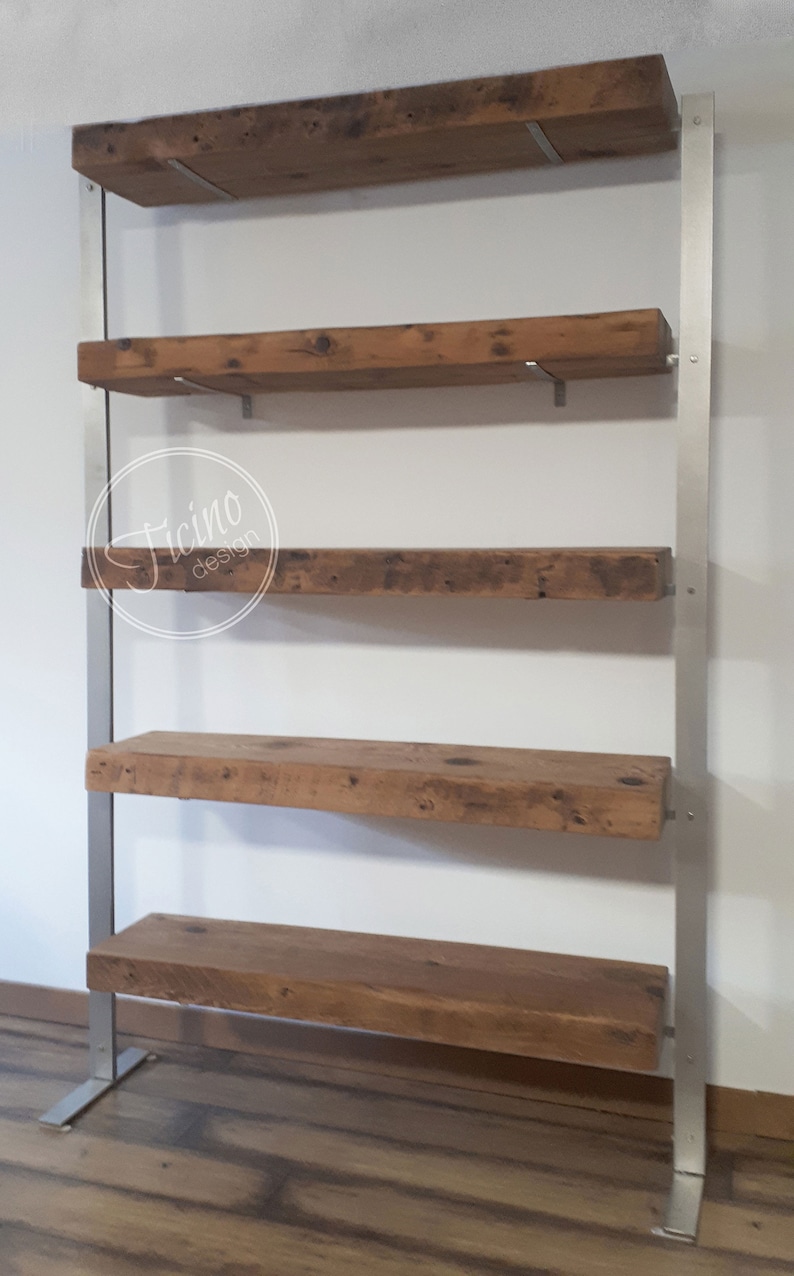 May include: A rustic wooden shelf unit with five shelves supported by a silver metal frame. The shelves are made of reclaimed wood with a natural finish. The metal frame has a simple design with straight lines and a base that is slightly wider than the top.