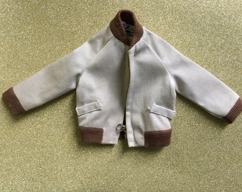 May include: A white bomber jacket with brown ribbed trim around the collar, cuffs, and waistband. The jacket has a zipper closure and two pockets.