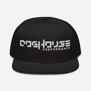 May include: Black baseball cap with a flat brim, featuring white embroidered text: "DOG HOUSE PERFORMANCE". The cap has a structured crown and a flat peak. The text is in a bold, stylized font.