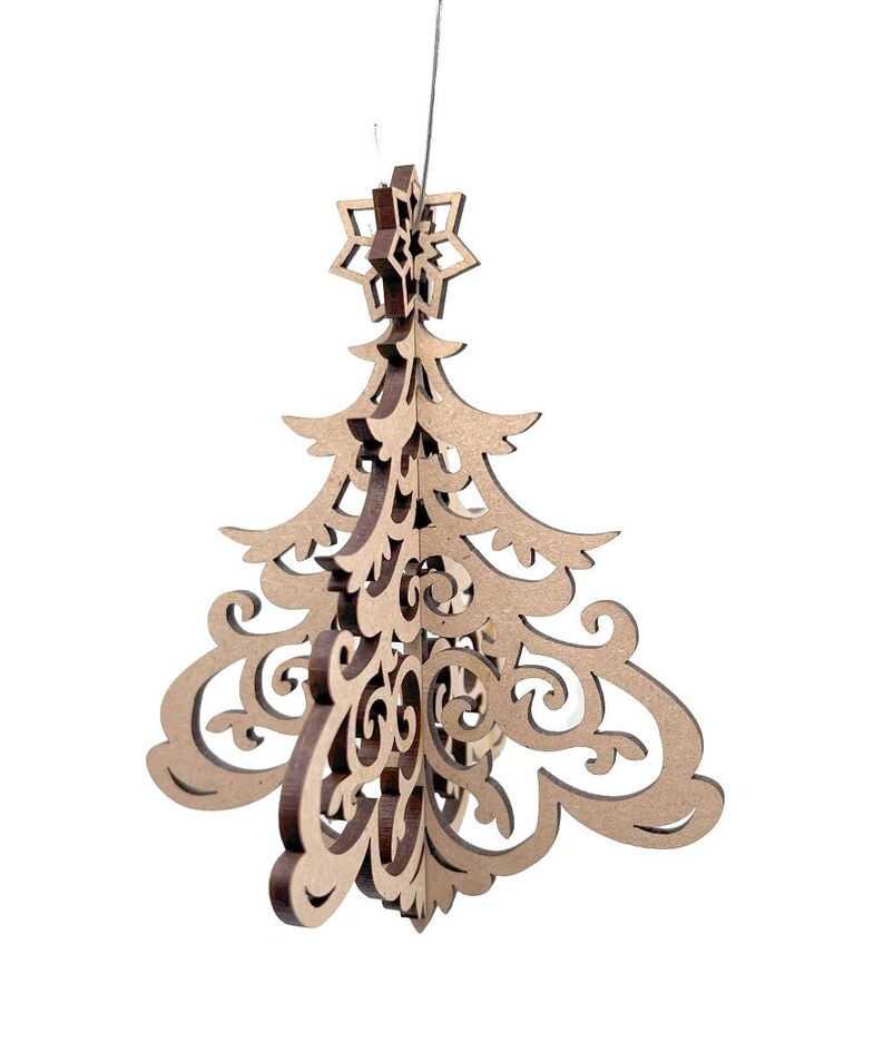 May include: A wooden Christmas tree ornament with a star on top. The ornament is made of layered, laser-cut wood with intricate scrollwork and a natural finish. It hangs from a thin string, perfect for holiday decor.