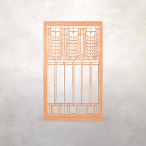 May include: An orange laser-cut architectural design, possibly a window or panel. The design features geometric patterns and vertical lines, with three small holes at the top. The style is reminiscent of Art Deco or Craftsman design.