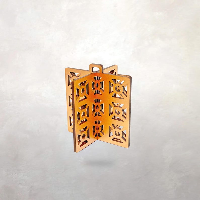 May include: Wooden decorative panels with a geometric design. The panels are a warm, light brown color and feature intricate cut-out patterns. The panels are connected at the base and have a small loop at the top.