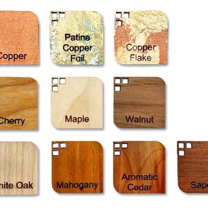 May include: A collection of square wooden and metal samples, each labeled with a material name. Materials include copper, copper foil, copper flake, cherry, maple, walnut, white oak, mahogany, aromatic cedar, and sapele.