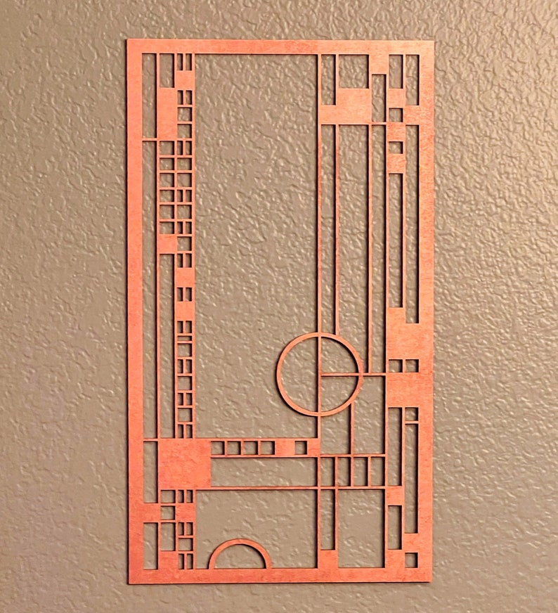 May include: A geometric design cut out of wood with a reddish-brown color. The design features a circle, squares, and rectangles.