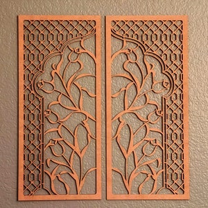 Pode incluir: Dois pain&eacute;is de madeira cortados a laser, com intrincados desenhos florais e geom&eacute;tricos. Os pain&eacute;is s&atilde;o de uma cor castanho-avermelhada quente e apresentam flores e vinhas estilizadas dentro de uma moldura retangular.