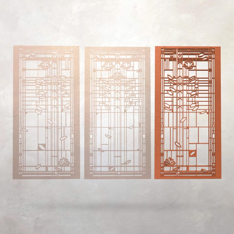 May include: Three rectangular decorative panels with a geometric design. The panels feature a grid pattern with floral and leaf motifs. The panel on the right is a warm orange colour, while the other two are a lighter, neutral tone. The design is reminiscent of stained glass.