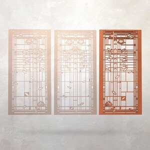 May include: Three rectangular decorative panels with a geometric design. The panels feature a grid pattern with floral and leaf motifs. The panel on the right is a warm orange color, while the other two are a lighter, neutral tone.