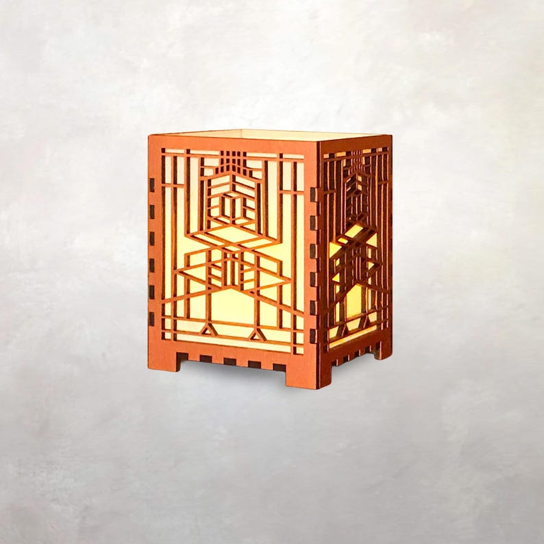 May include: A wooden, geometric-patterned lamp with a warm, yellow glow emanating from within. The lamp has a rectangular shape with intricate cut-out designs, creating a decorative and artistic lighting fixture. The lamp is made of wood and has a natural finish.