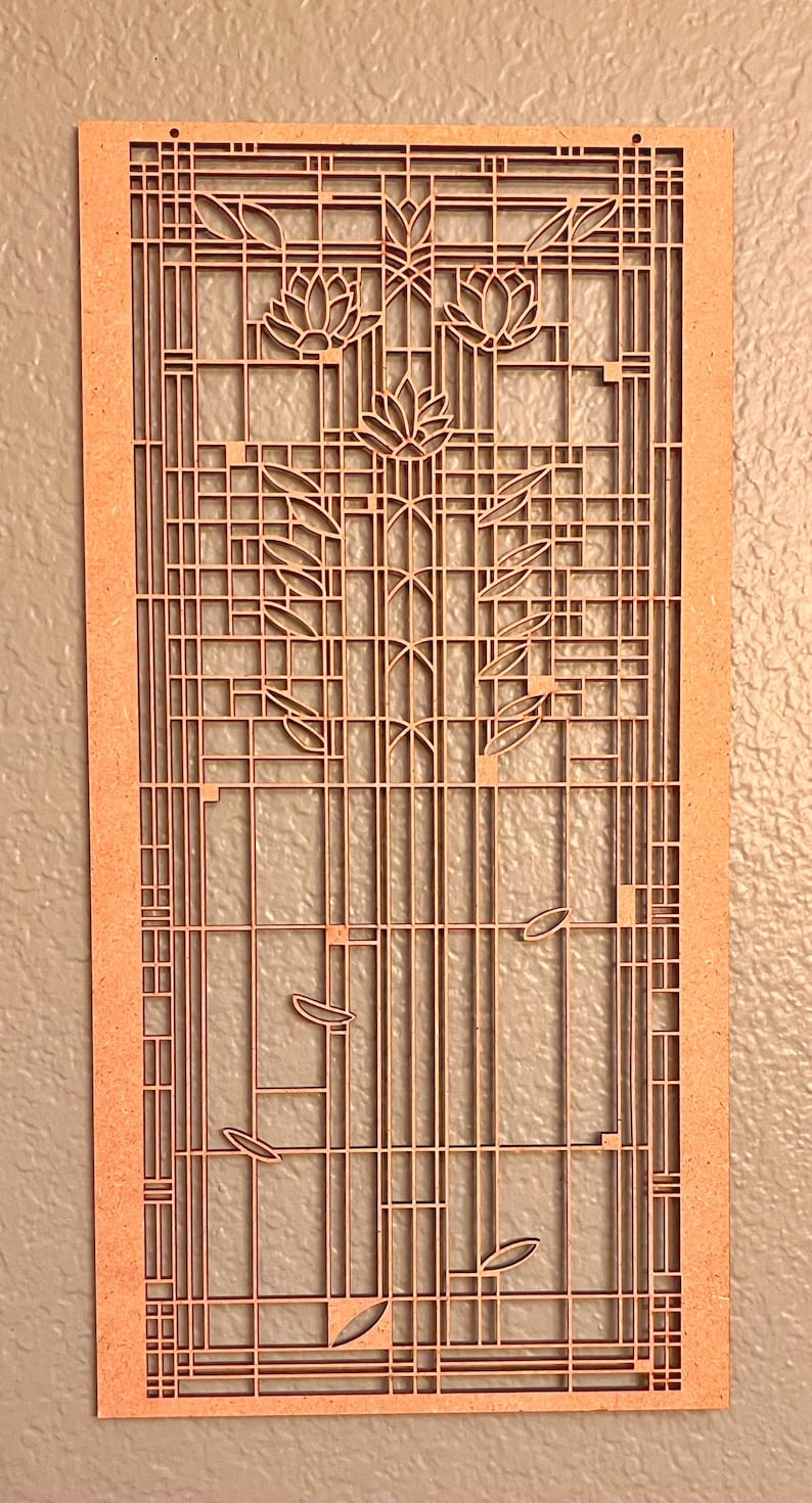 Może przedstawiać: Drewniana dekoracja ścienna z geometrycznym wzorem przedstawiającym stylizowany motyw kwiatowy. Projekt przypomina styl Art Nouveau.