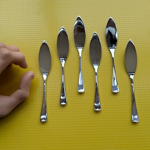 May include: A handmade, wooden cutting board with a natural finish. The board features a rectangular shape with rounded corners and a juice groove. It measures approximately 16 inches long, 12 inches wide, and 1 inch thick.