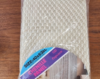 May include: A packaged cream-colored chenille panel with a honeycomb pattern. The package is labeled "HENILLE PANEL" and "Popcorn", with dimensions of 40x63 inches. The package contains one panel.