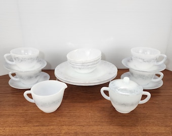 May include: A vintage white and gray patterned tea set. The set includes teacups, saucers, small bowls, plates, a creamer, and a lidded sugar bowl. The pattern has a marbled appearance.