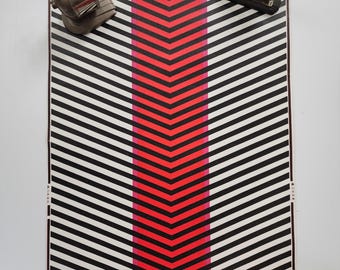 May include: A graphic design featuring a black and white chevron pattern with a central red and pink vertical stripe. A vintage pencil sharpener and a black sandal are placed on the top corners of the design.
