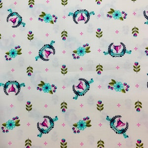 May include: White fabric with a repeating pattern of blue and pink floral designs, green leaves, and a trophy with the text "I'm a winner" on a blue ribbon.
