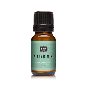 May include: A small amber glass bottle with a black cap, containing Winter Mint premium fragrance oil. The label is green with white text and a black and white logo.