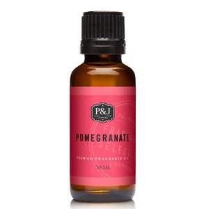 May include: A 30 ml bottle of pomegranate fragrance oil. The bottle is amber glass with a black cap. The label is red with black text that reads "P&J Trading", "Fragrance", "Pomegranate", "Selection", "Premium Fragrance Oil", and "30 ml".
