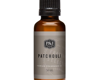 May include: A brown glass bottle with a black cap, labeled "P&J Trading" and "Patchouli Select Premium Fragrance Oil 30 ML".
