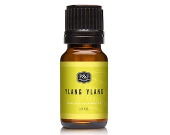 Op de afbeelding: Een 10 ml amberkleurige glazen fles met Ylang Ylang etherische olie met een zwarte schroefdop. Het etiket is geel met zwarte tekst die "P&J Trading, Premium geur olie, Ylang Ylang Selection, 10 ml" luidt.