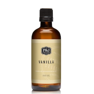 May include: A brown glass bottle with a black cap, containing vanilla fragrance oil. The label is cream-colored with black text that reads "P&J Trading", "Vanilla Select", "Premium Fragrance Oil", and "100 ml".