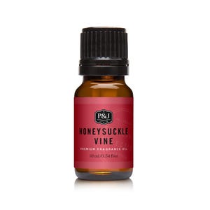 May include: A small amber glass bottle with a black cap. The label is red with the words "HONEYSUCKLE VINE" and "PREMIUM FRAGRANCE OIL". The bottle contains 10 ml / 0.34 fl oz of oil.